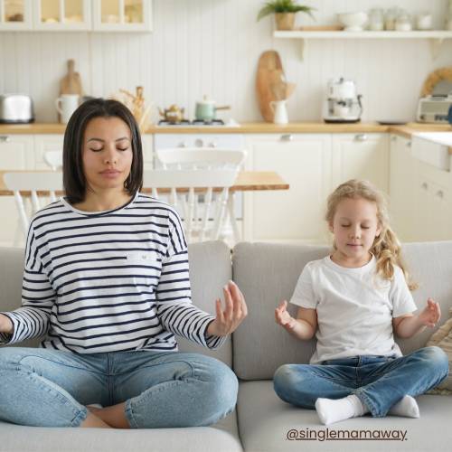 Mother and daughter meditating in a clear clean space